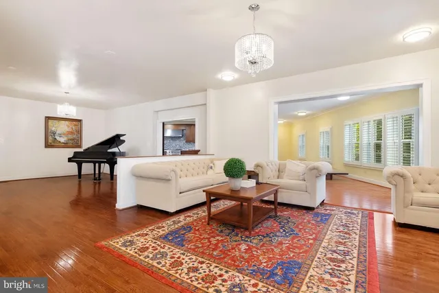a living room with furniture wooden floor and a rug