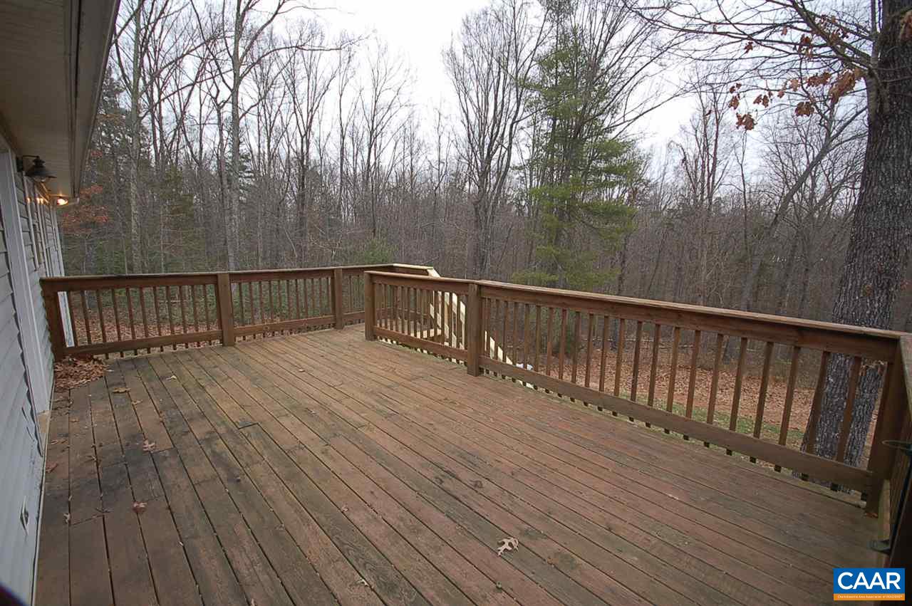 5075 Celt Road Stanardsville, VA 22973 - Photo 14 of 36 a balcony with wooden floor and trees