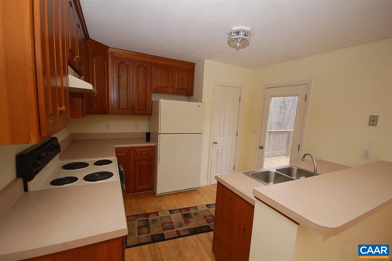 5075 Celt Road Stanardsville, VA 22973 - Photo 17 of 36 a kitchen with a sink a stove and a refrigerator