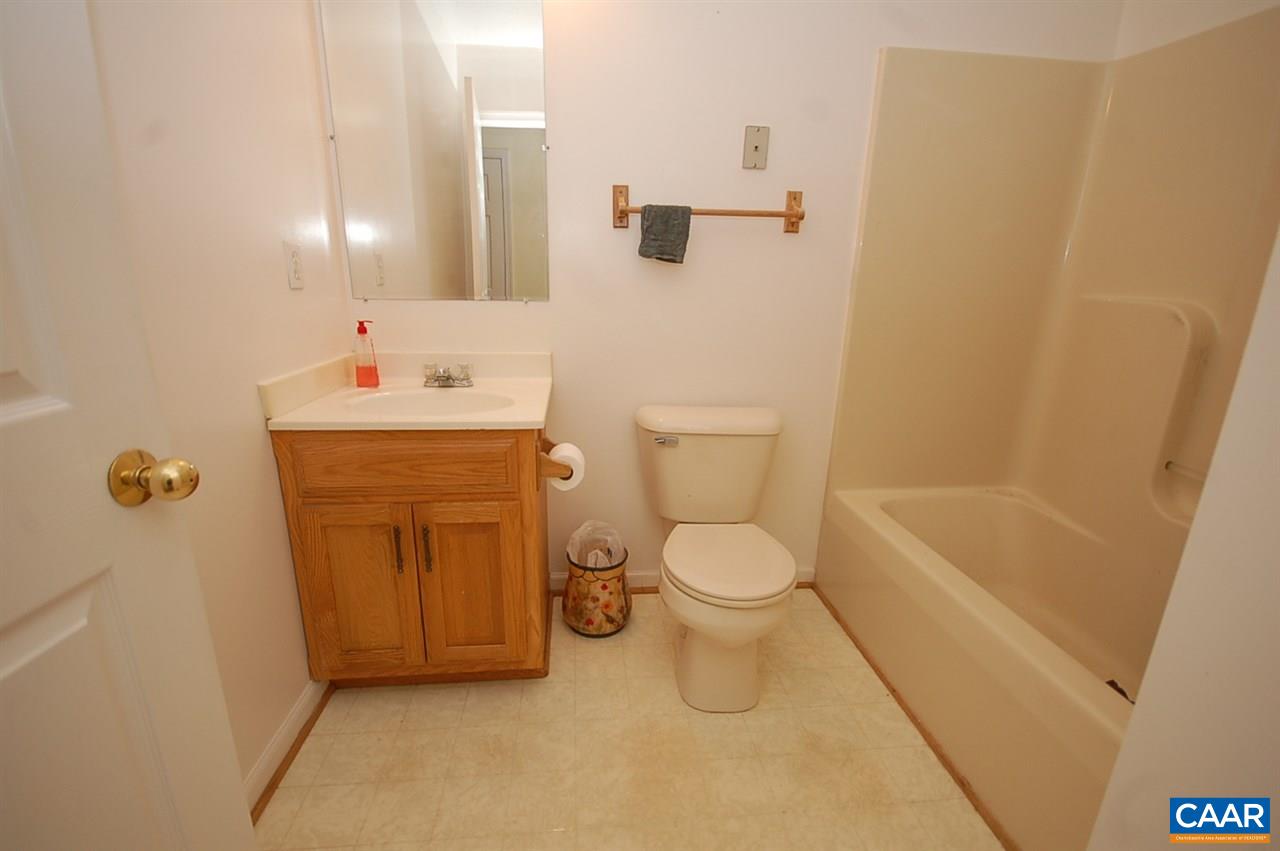 5075 Celt Road Stanardsville, VA 22973 - Photo 21 of 36 a bathroom with a toilet a sink a tub and mirror