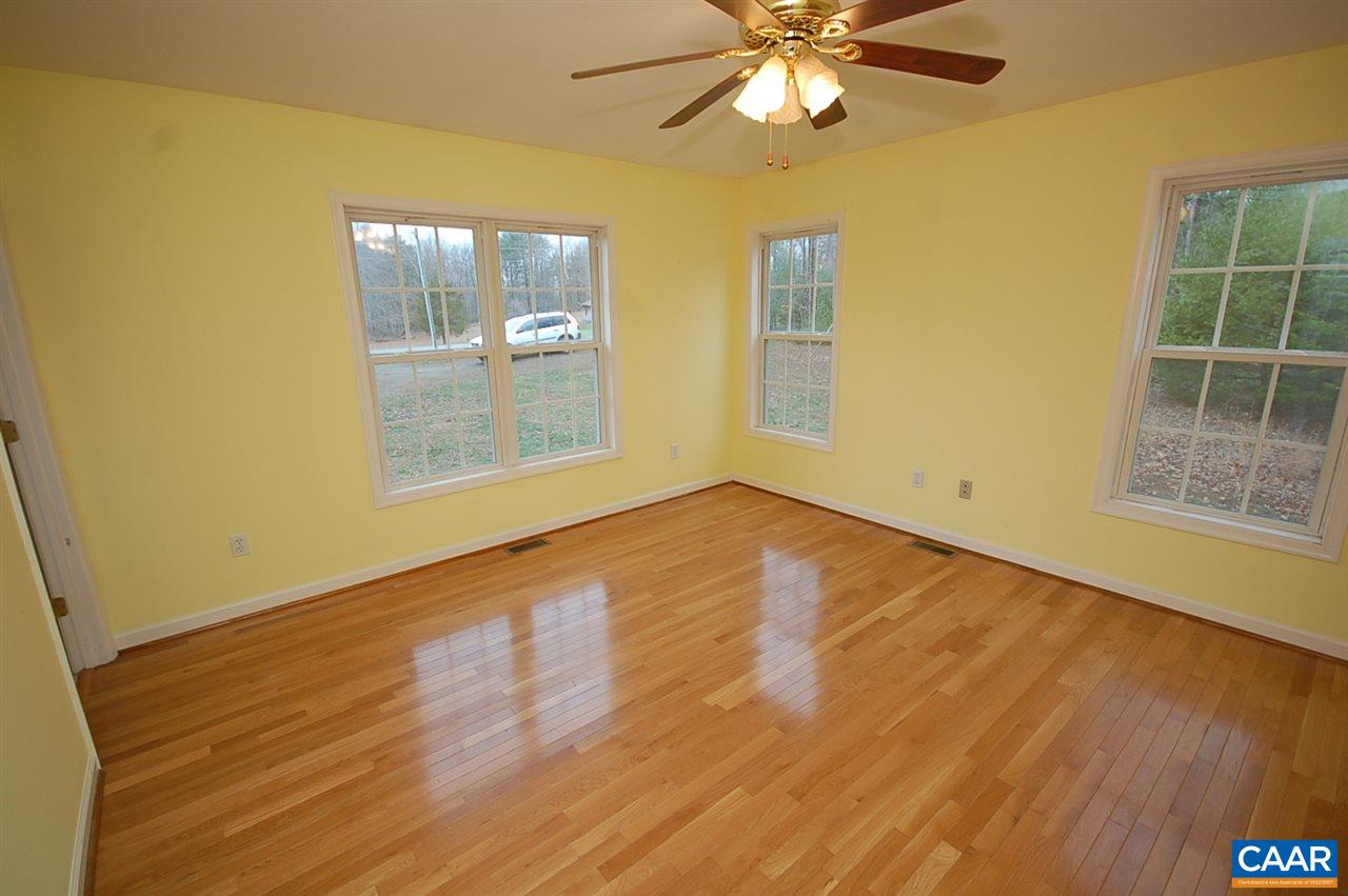 5075 Celt Road Stanardsville, VA 22973 - Photo 22 of 36 a view of an empty room with wooden floor and a window