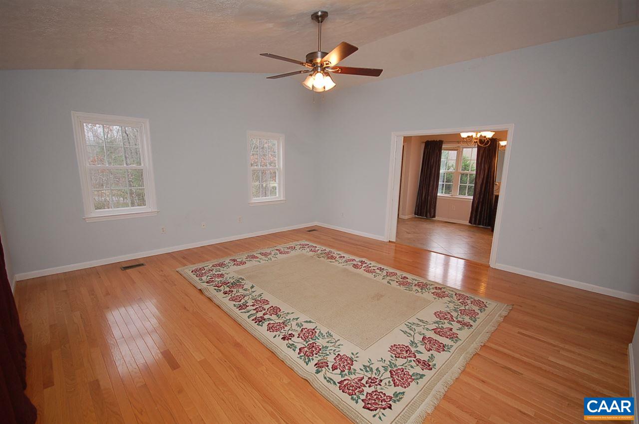 5075 Celt Road Stanardsville, VA 22973 - Photo 29 of 36 an empty room with wooden floor and windows