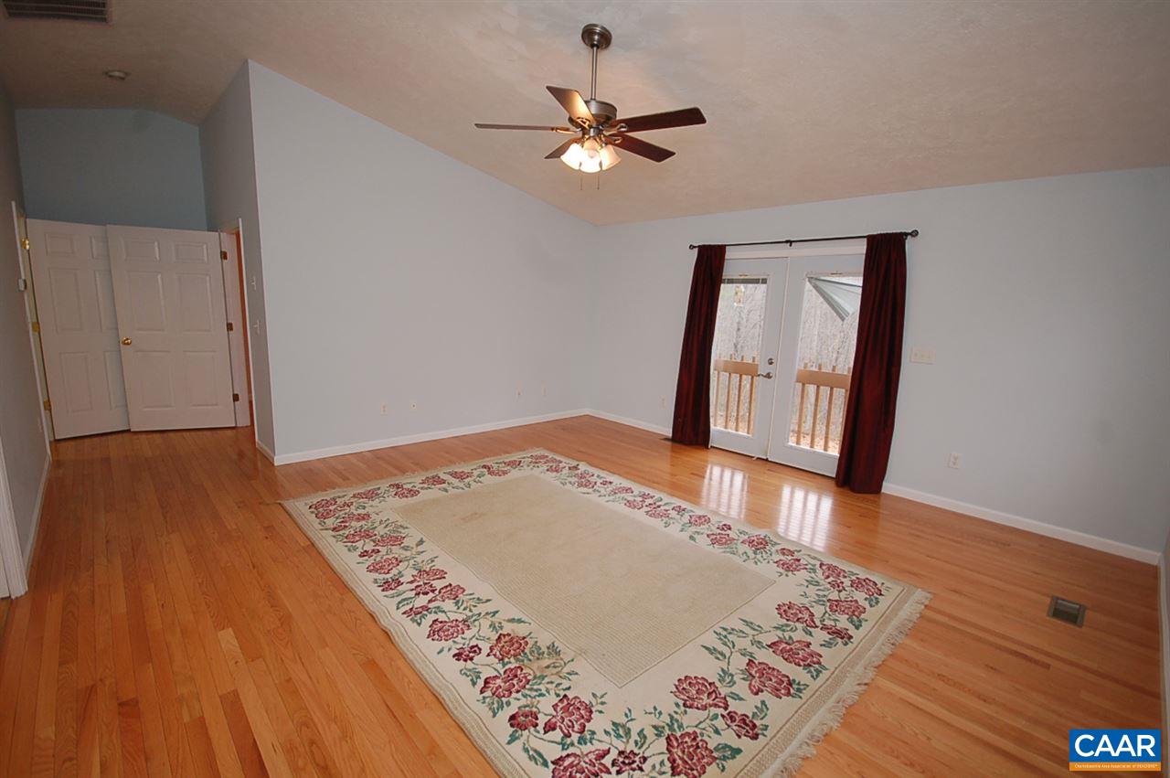 5075 Celt Road Stanardsville, VA 22973 - Photo 31 of 36 a view of an empty room with wooden floor and a ceiling fan
