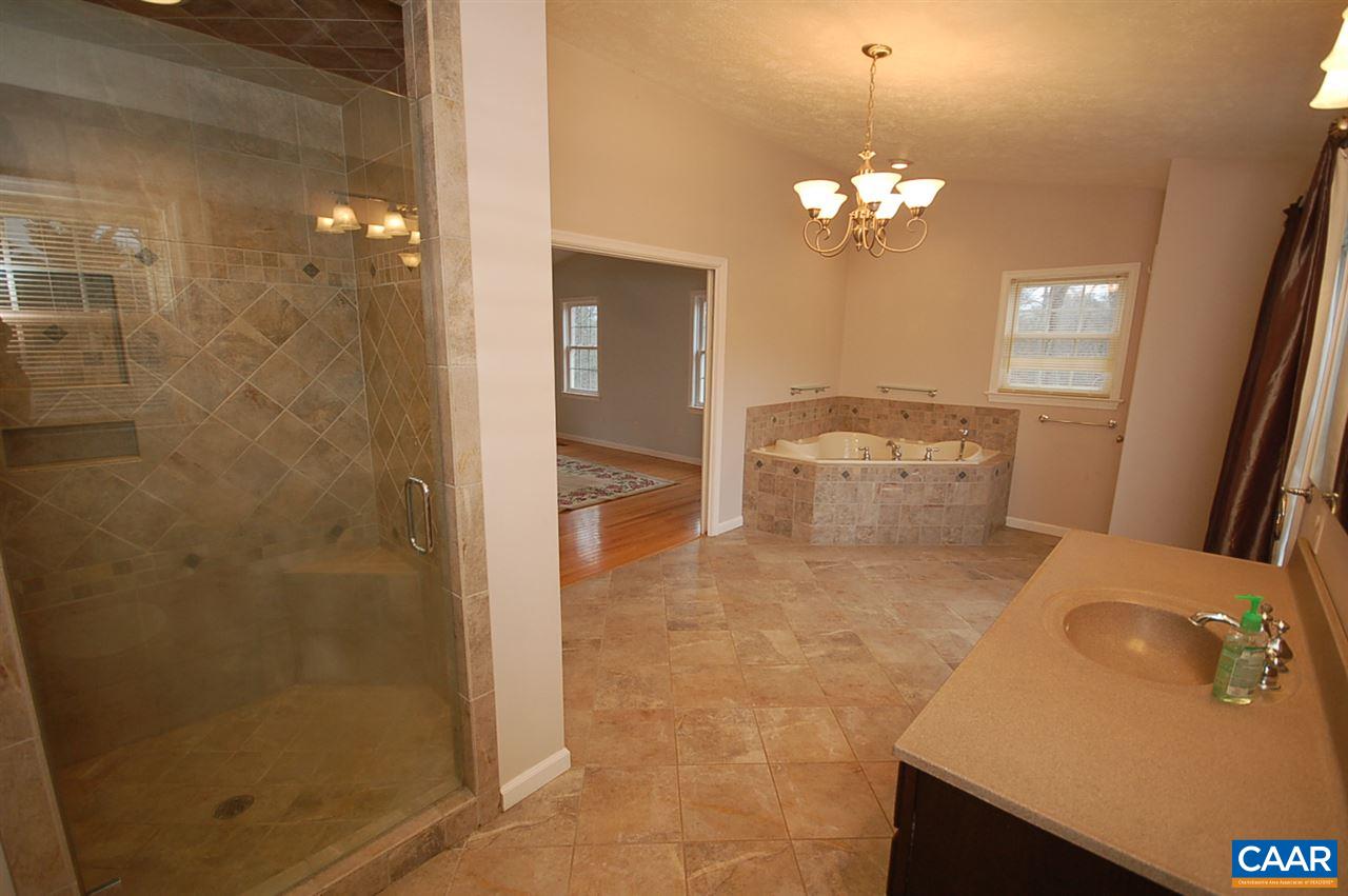 5075 Celt Road Stanardsville, VA 22973 - Photo 36 of 36 a bathroom with a sink mirror and a shower
