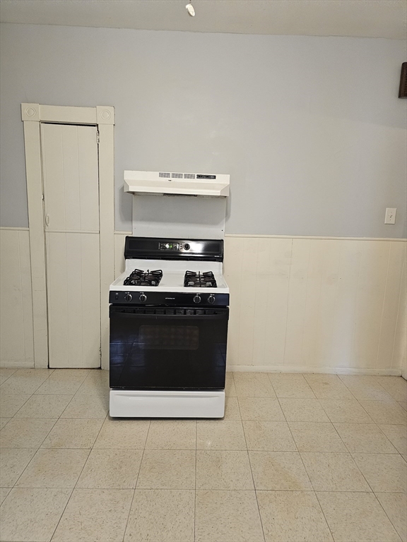 404 Stevens Street, Unit 2 Lowell, MA 01851 - Photo 4 of 12 a stove top oven sitting inside of a kitchen