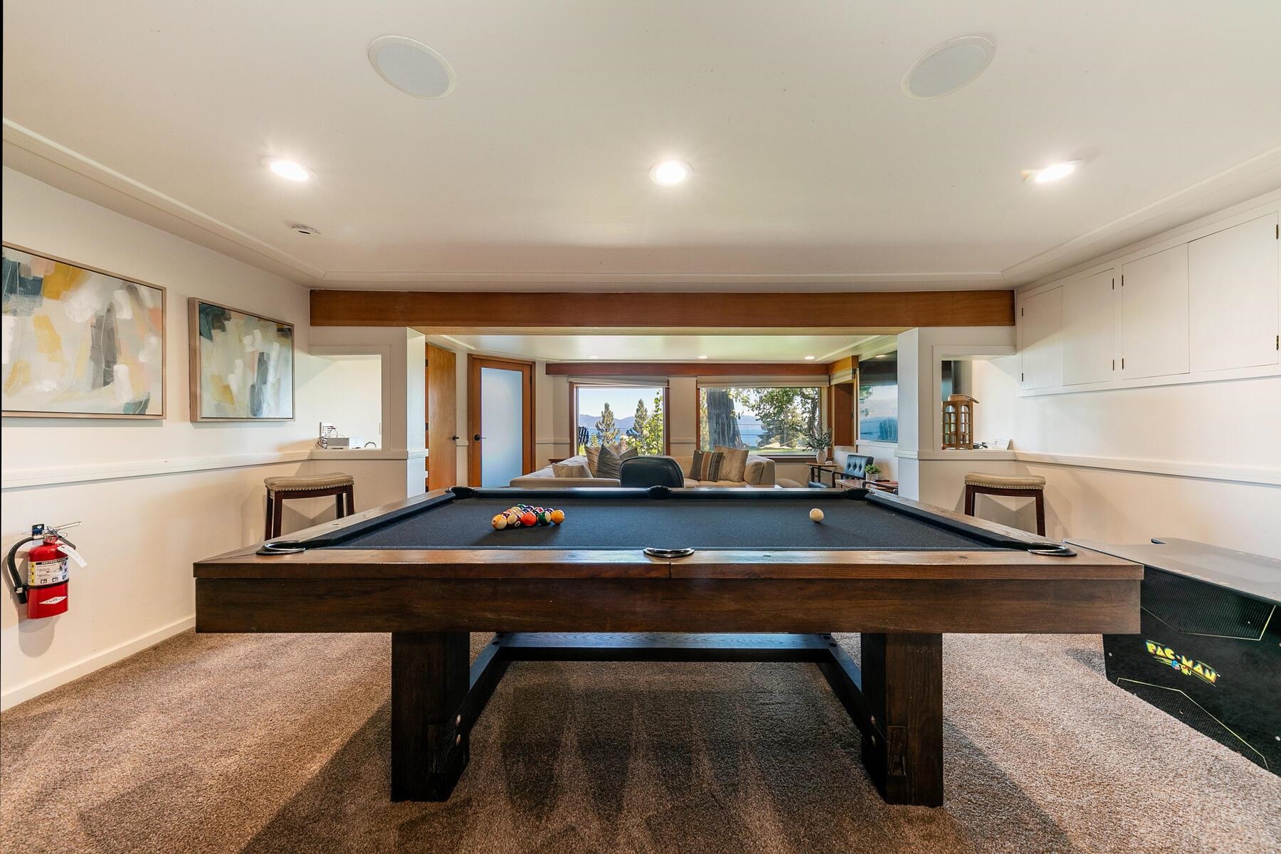488 Old County Road Carnelian Bay, CA 96140 - Photo 12 of 21 a living room with table table tennis pool table and windows