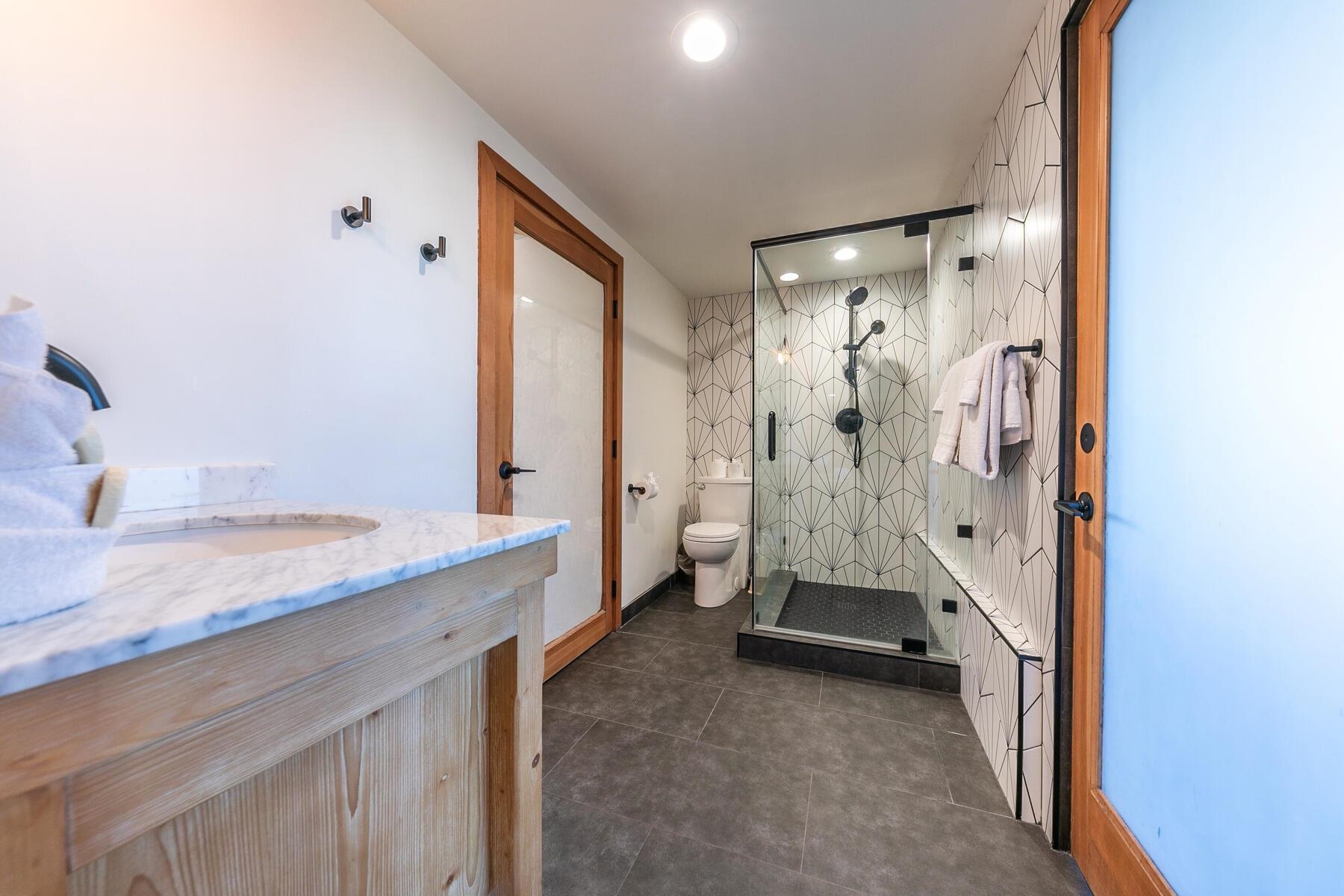 488 Old County Road Carnelian Bay, CA 96140 - Photo 13 of 21 a bathroom with a granite countertop sink and a shower