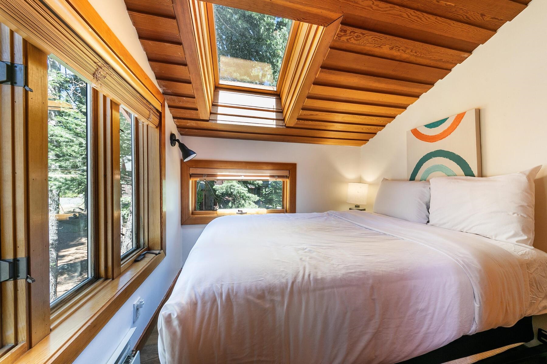 488 Old County Road Carnelian Bay, CA 96140 - Photo 18 of 21 a bedroom with a bed and a large window with outer view