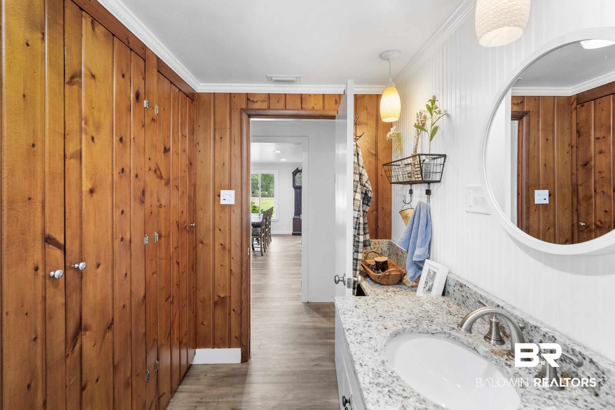 16475 River Park Road Fairhope, AL 36532 - Photo 28 of 37 Bathroom featuring vanity, ornamental molding, wooden walls, and hardwood / wood-style flooring