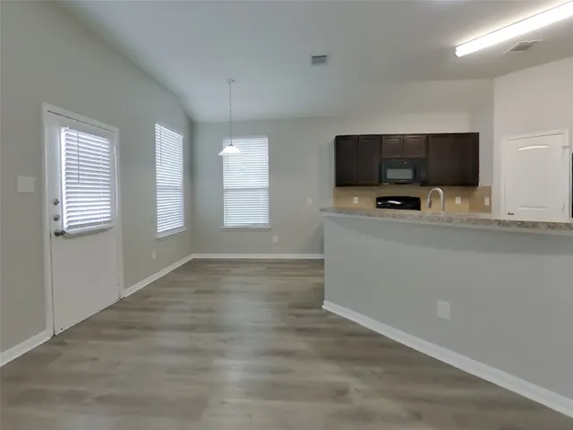 a room with a flat screen tv and a window