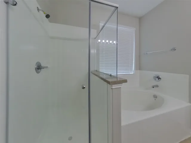 a bathroom with a bathtub and shower
