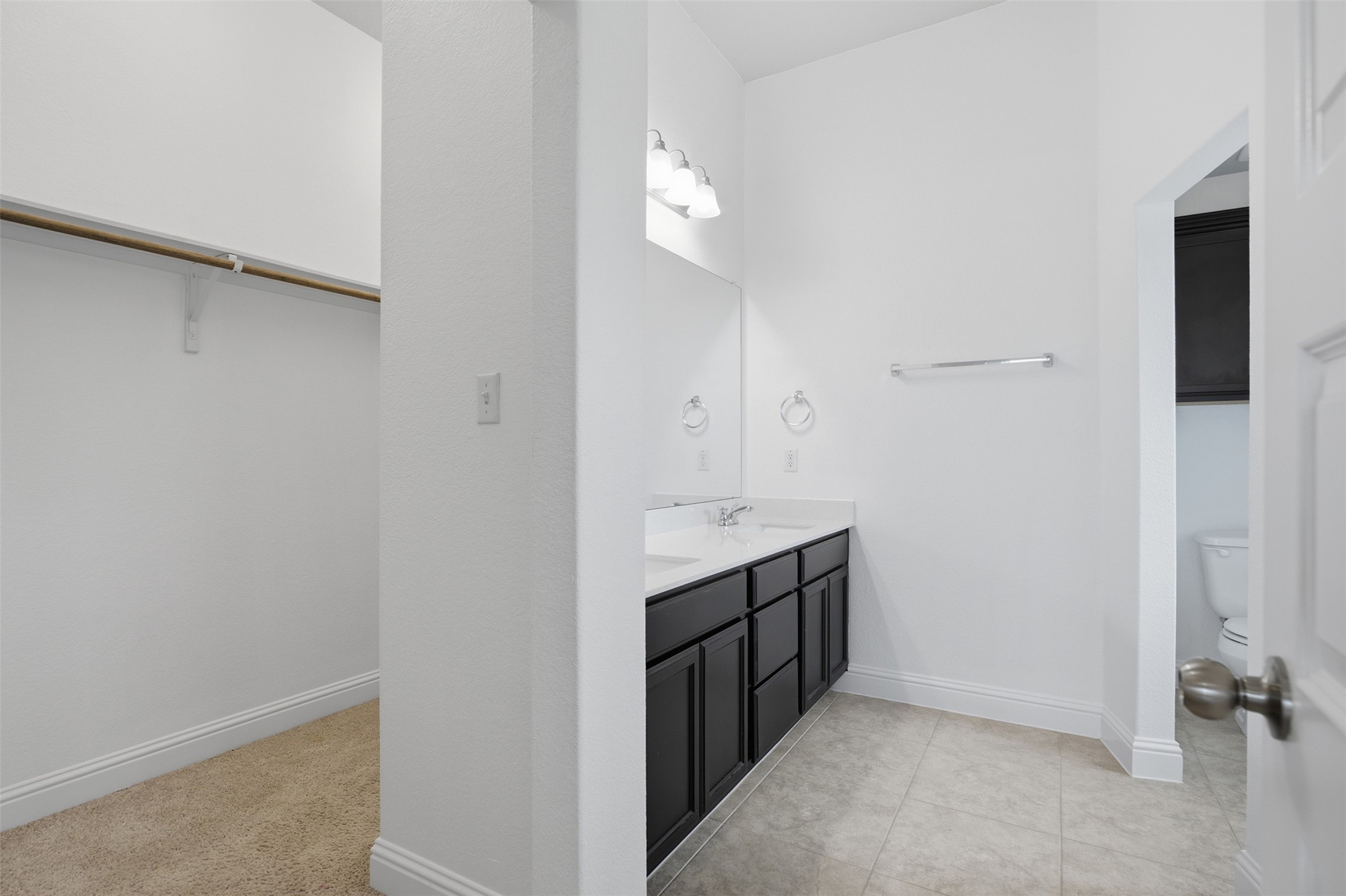 321 Gaida Loop Georgetown, TX 78628 - Photo 19 of 26 A spacious master bathroom features dual vanity sinks and connects directly to a large closet.