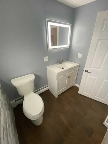a white toilet sitting next to a bathroom sink