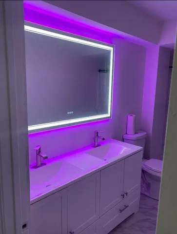 a bathroom with a mirror and a sink