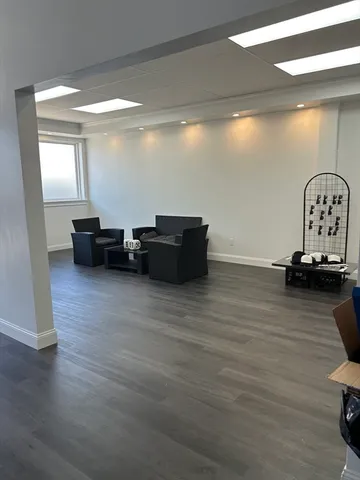 a view of living room with furniture and wooden floor