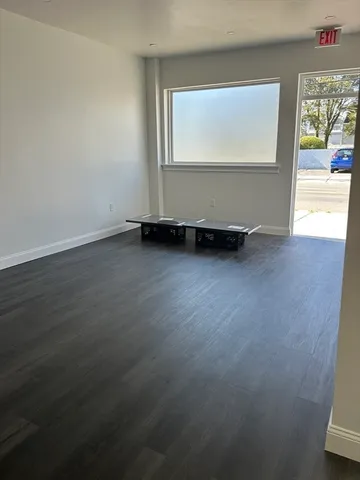a view of a room with wooden floor and a window