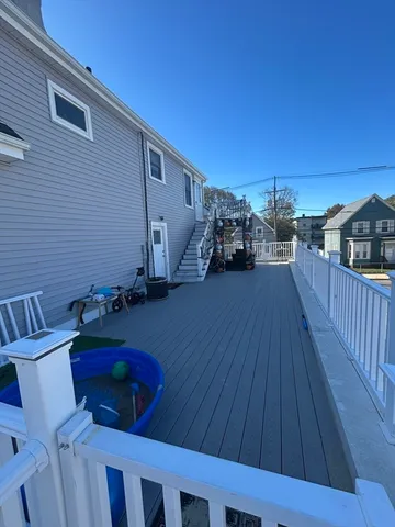 a view of a deck with table and chairs with wooden floor and fence