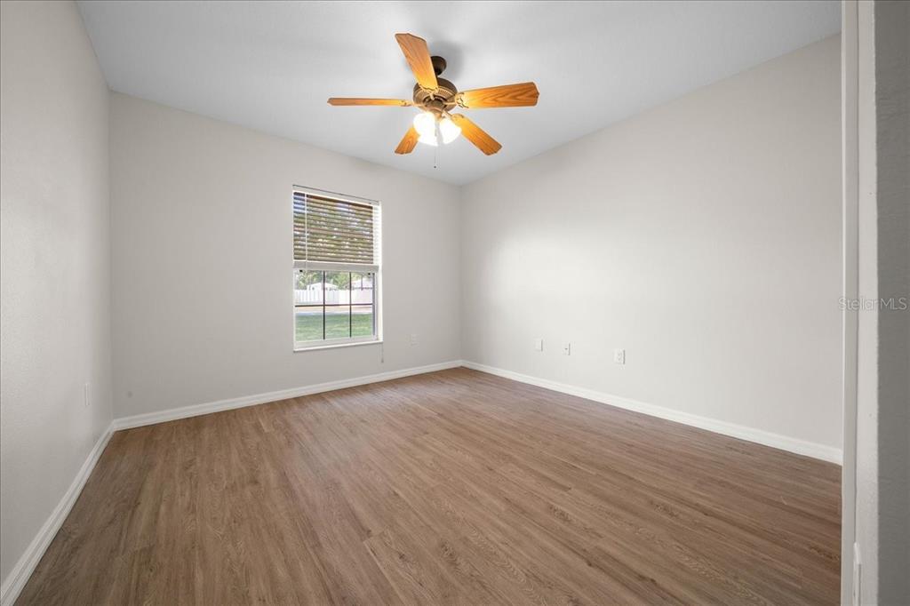 234 Locust Lane Ocala, FL 34472 - Photo 63 of 71 an empty room with wooden floor and windows