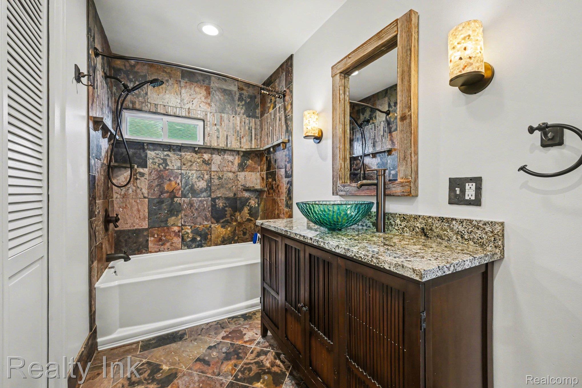 16944 Franklin Road Northville, MI 48168 - Photo 8 of 11 Full bath featuring a closet, vanity, dark stone finish flooring, and shower / bathtub combination