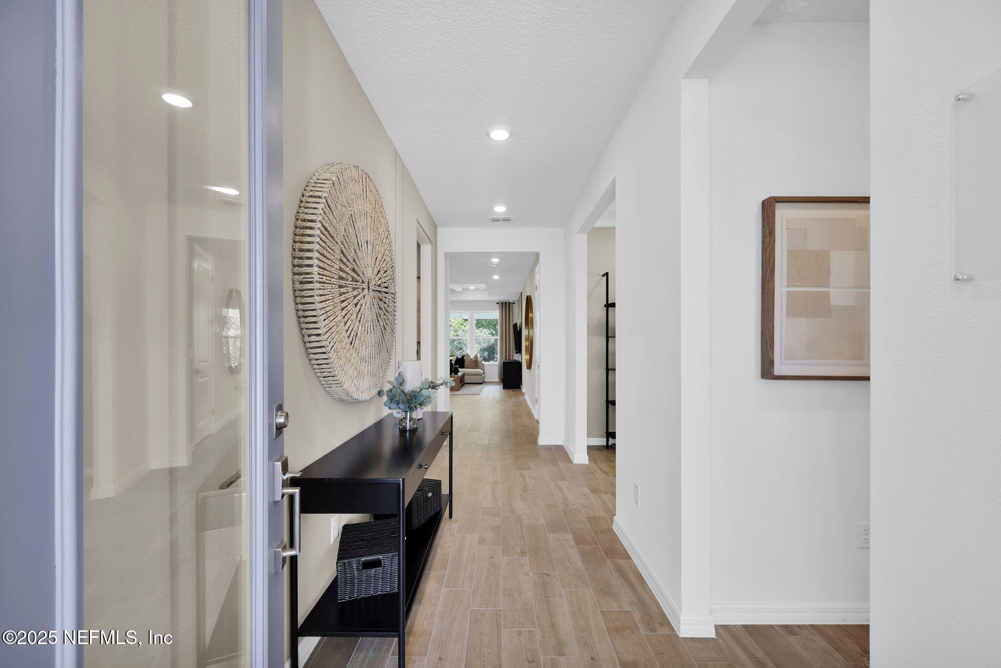 124 Headstream Drive St. Johns, FL 32259 - Photo 3 of 22 a view of a hallway with wooden floor and staircase