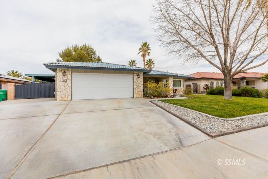 908 North Inyo Street Ridgecrest, CA 93555 - Photo 5 of 46 a front view of a house with a yard and garage