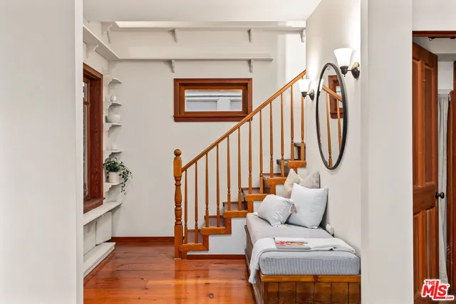a view of entryway and hall with wooden floor