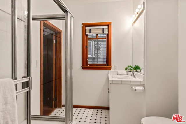 a bathroom with a toilet sink and mirror