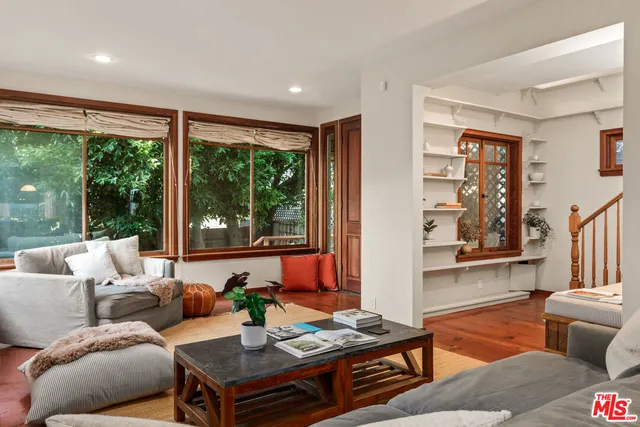 a living room with furniture and large window