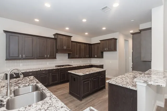 a kitchen with wooden cabinets and a stove top oven