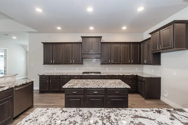 a kitchen with a stove sink and cabinets
