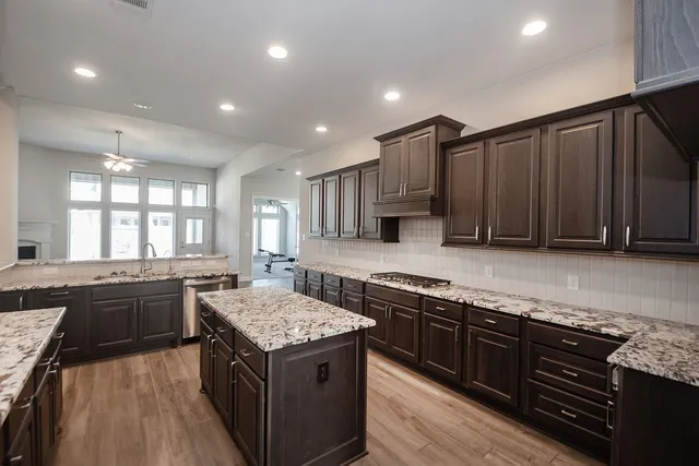 a kitchen with stainless steel appliances granite countertop a stove and a refrigerator