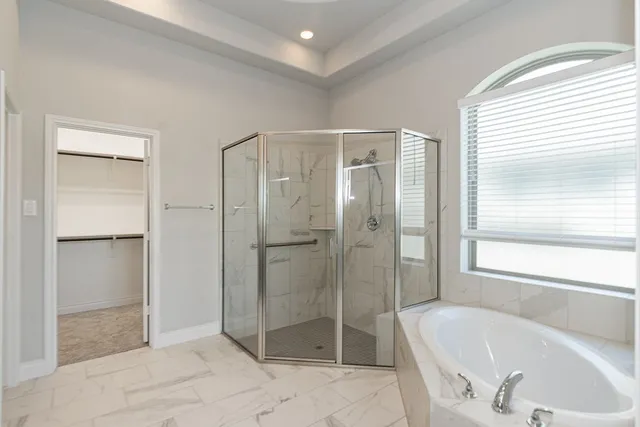 a bathroom with a granite countertop sink a toilet and bathtub