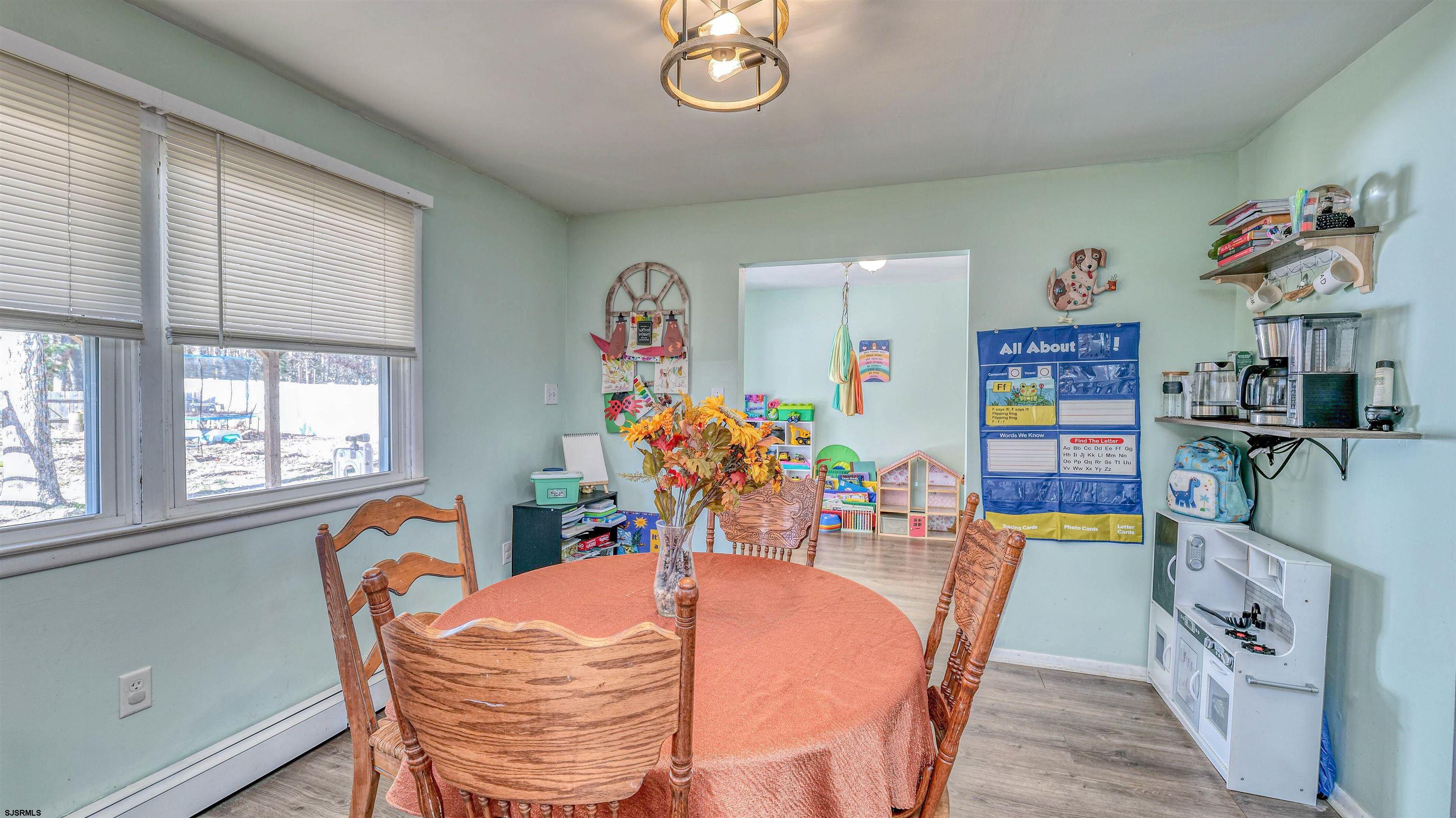 61 Leitz Boulevard Tuckerton, NJ 08087 - Photo 11 of 24 a dining room with furniture a rug and wooden floor