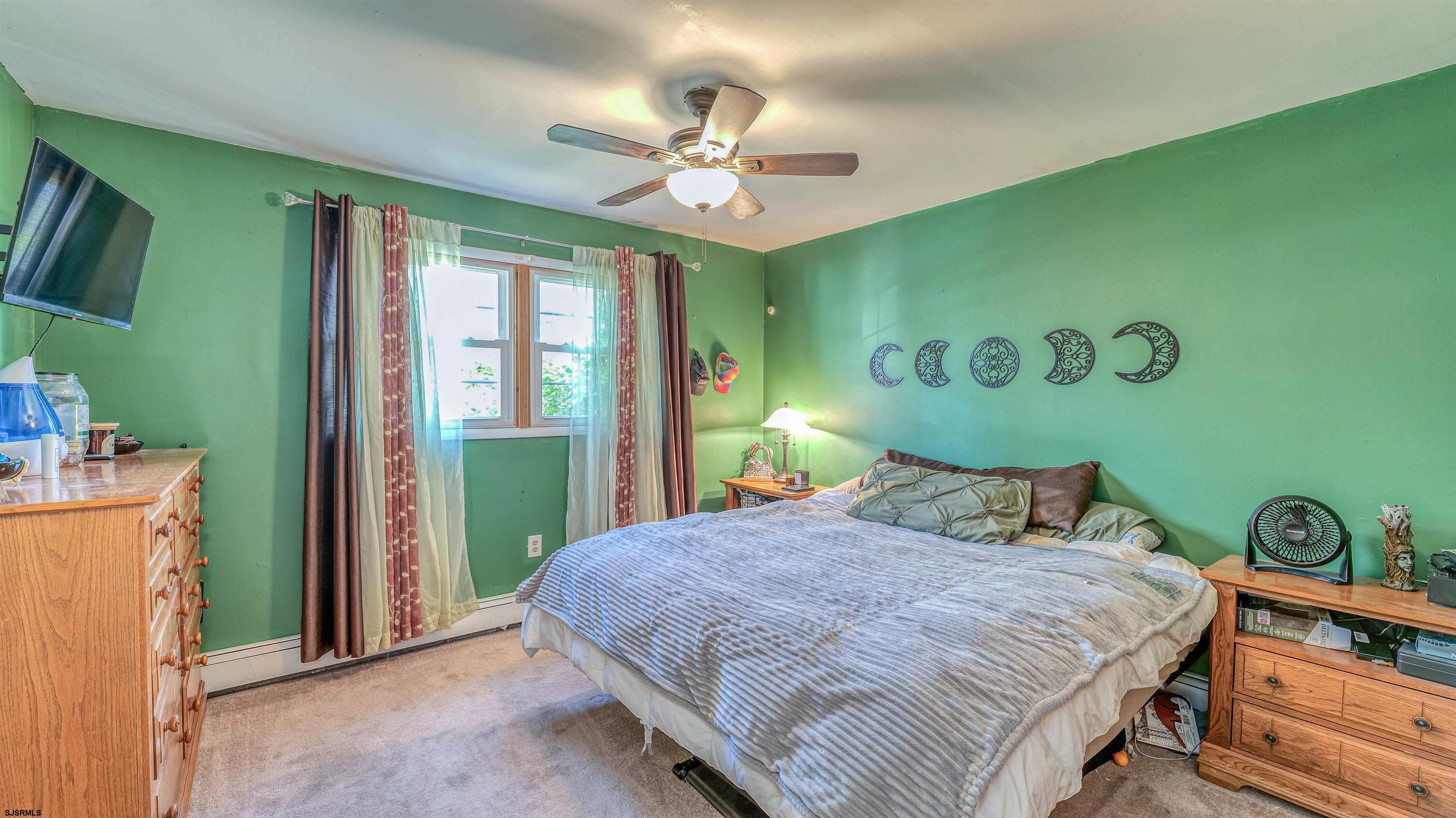61 Leitz Boulevard Tuckerton, NJ 08087 - Photo 14 of 24 a bedroom with a bed and a chandelier