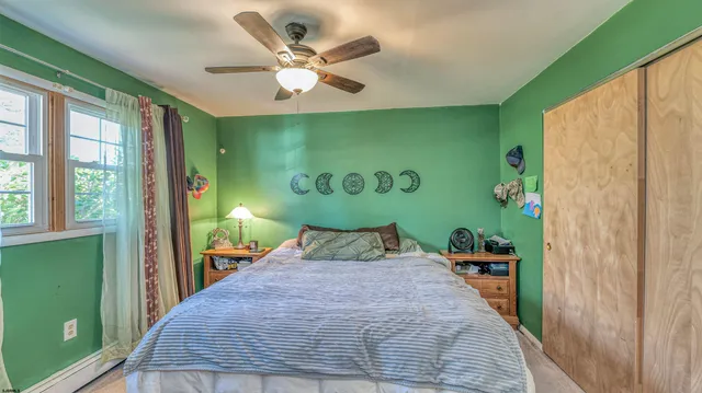 a bedroom with a large bed and a large window