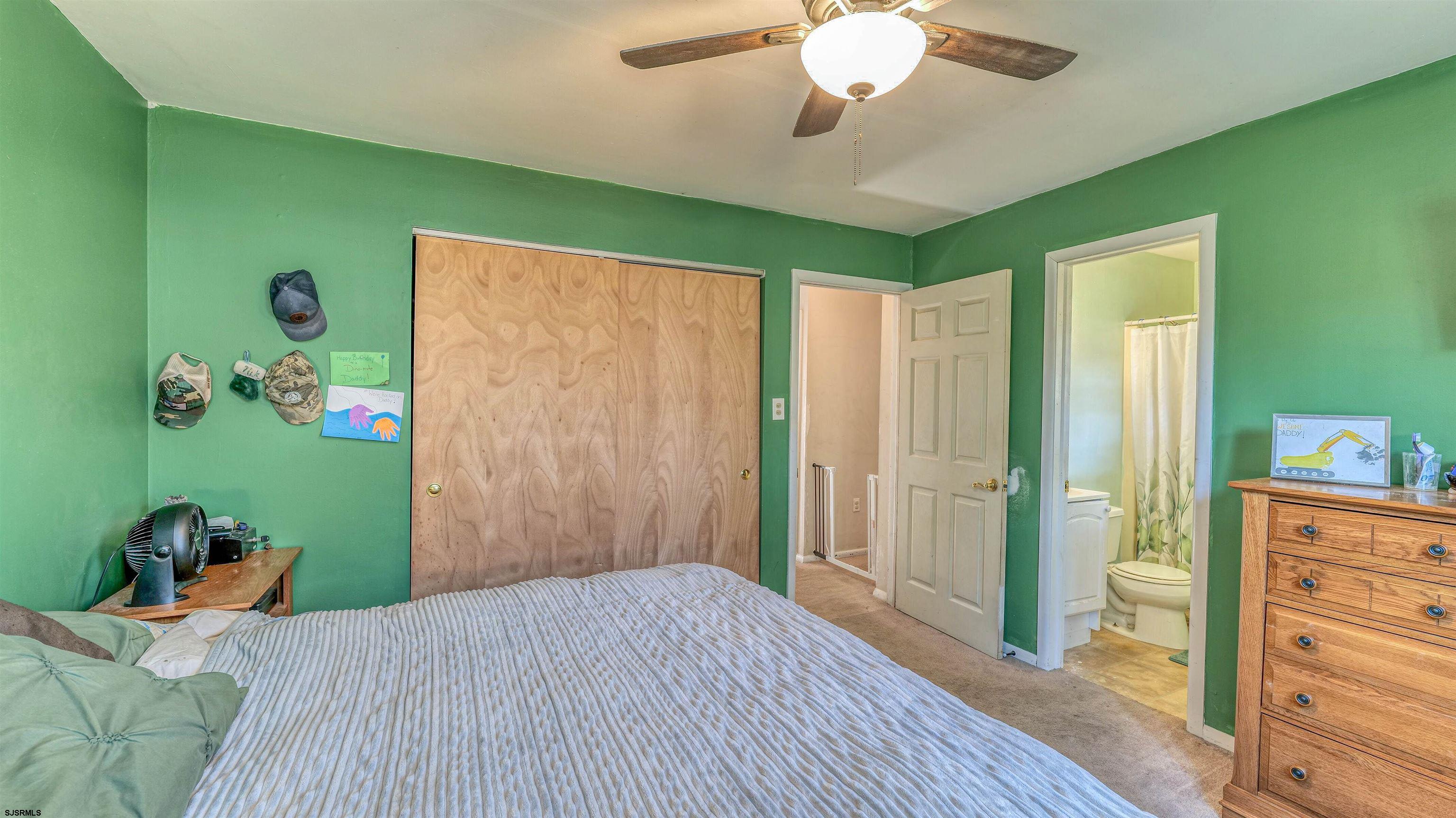 61 Leitz Boulevard Tuckerton, NJ 08087 - Photo 16 of 24 a bedroom with a bed and a chandelier