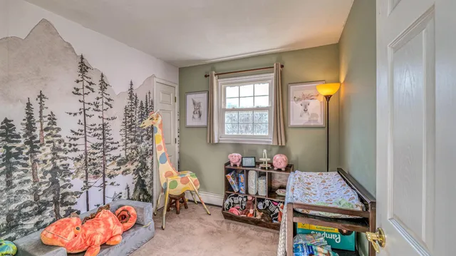 walk in closet with window and chair