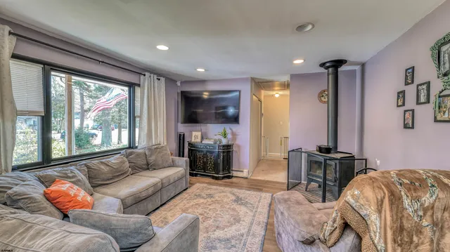 a living room with furniture fireplace and a large window