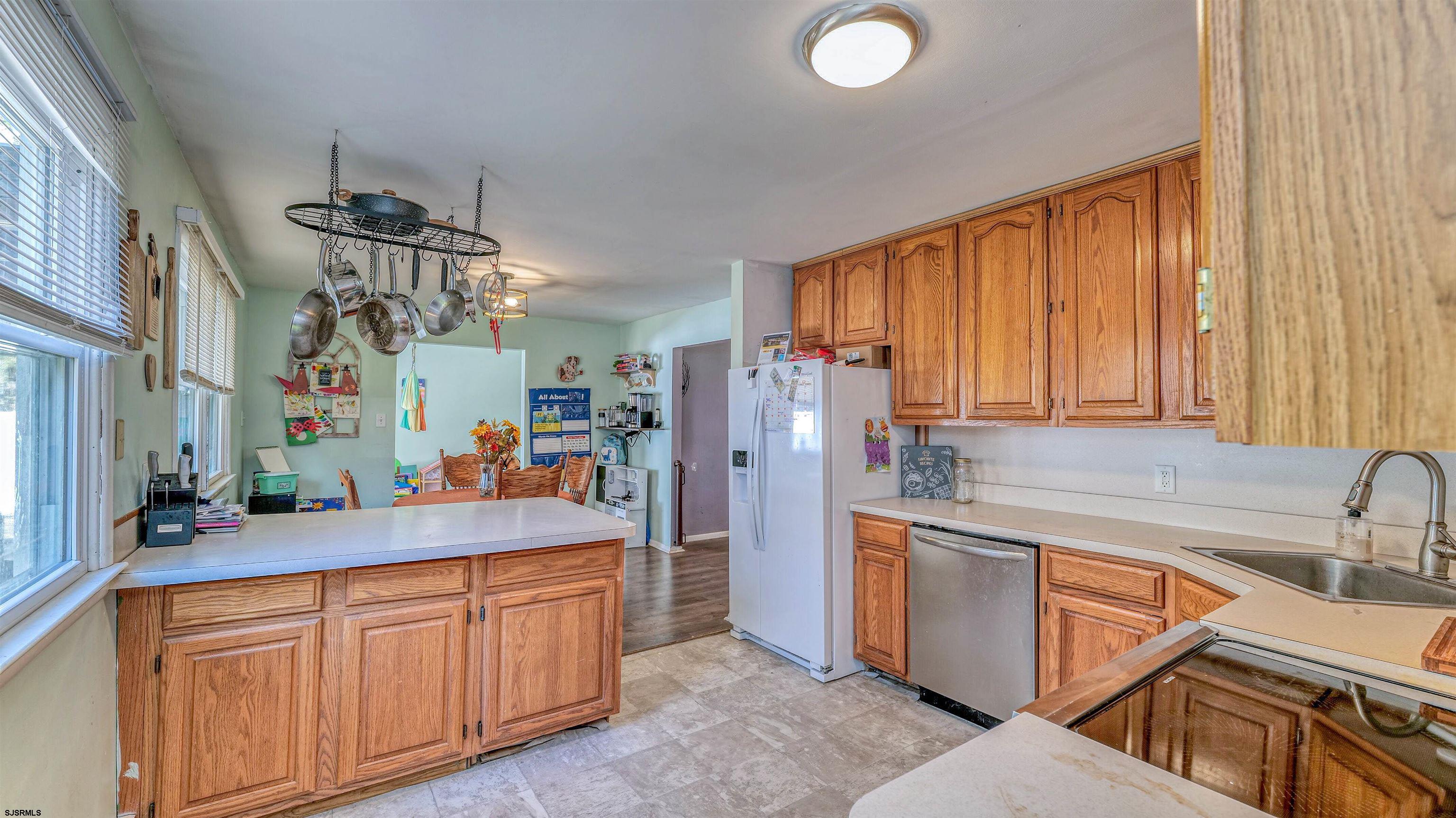 61 Leitz Boulevard Tuckerton, NJ 08087 - Photo 10 of 24 a kitchen with stainless steel appliances granite countertop a sink dishwasher stove and refrigerator with wooden floor
