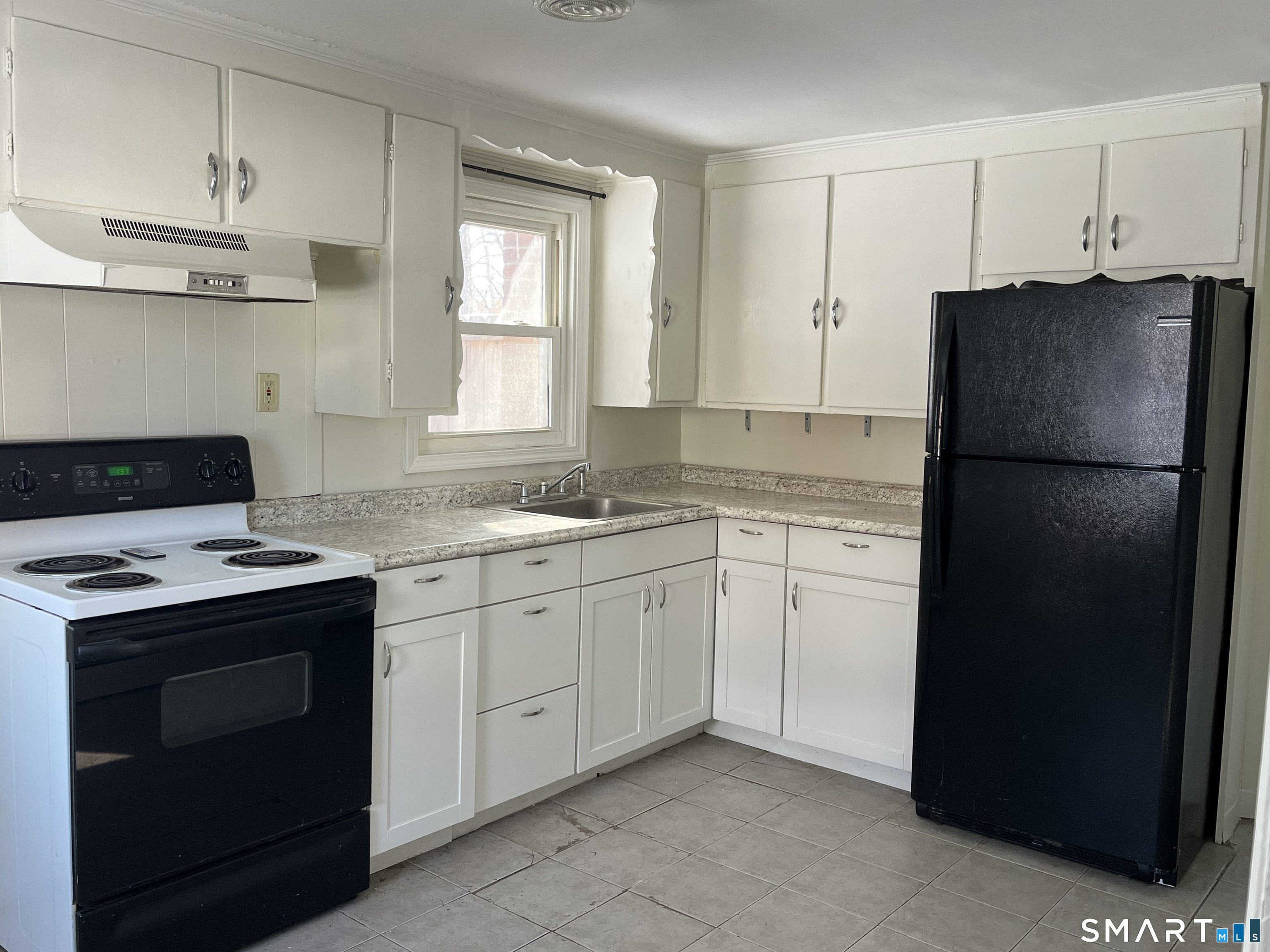 20 John Street Southington, CT 06489 - Photo 7 of 17 a kitchen with a stove sink and refrigerator