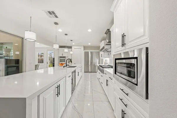 a dining room with furniture and view of kitchen