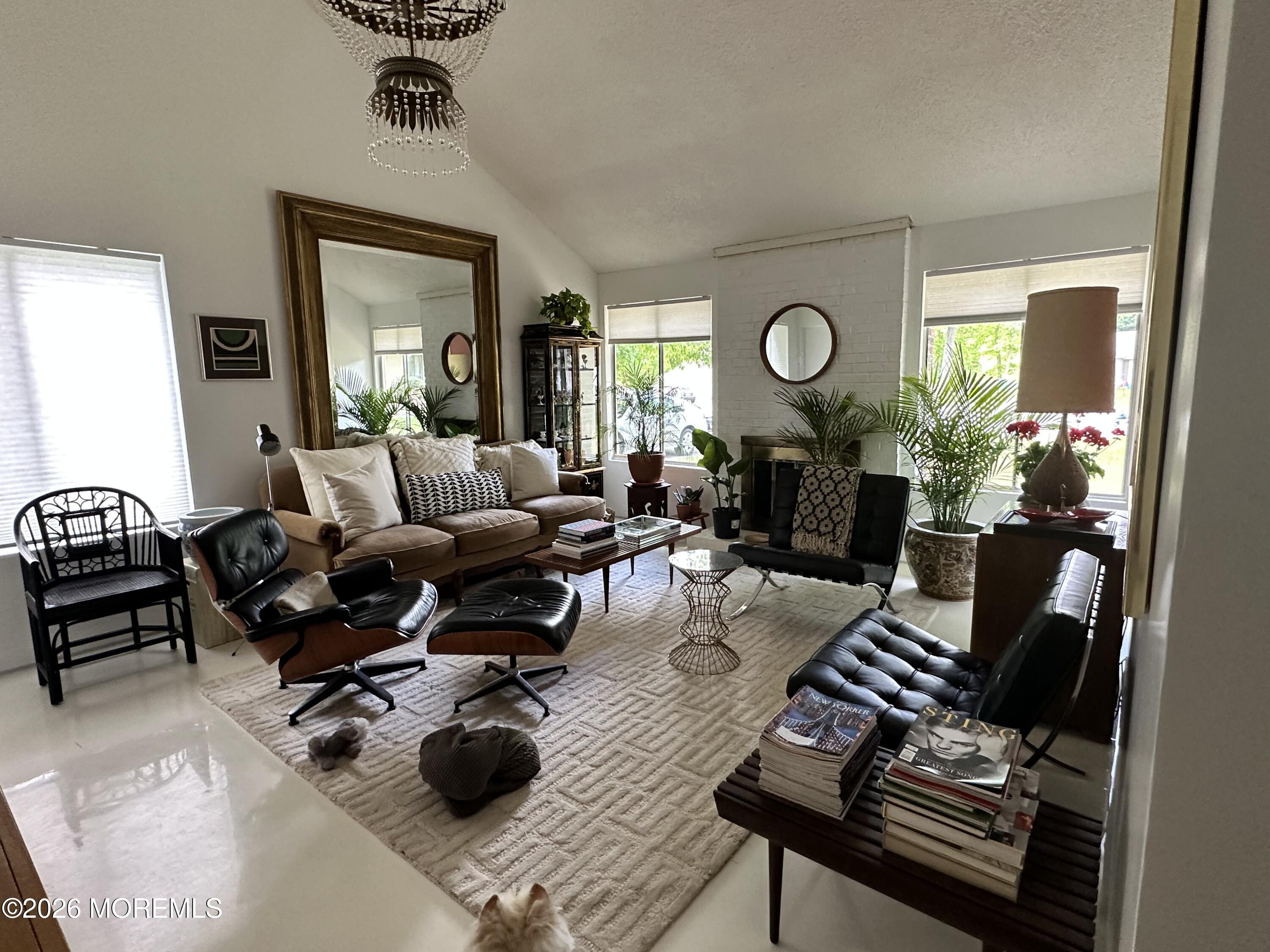 18 Liverpool Court Jackson, NJ 08527 - Photo 1 of 16 a living room with furniture a chandelier and a window