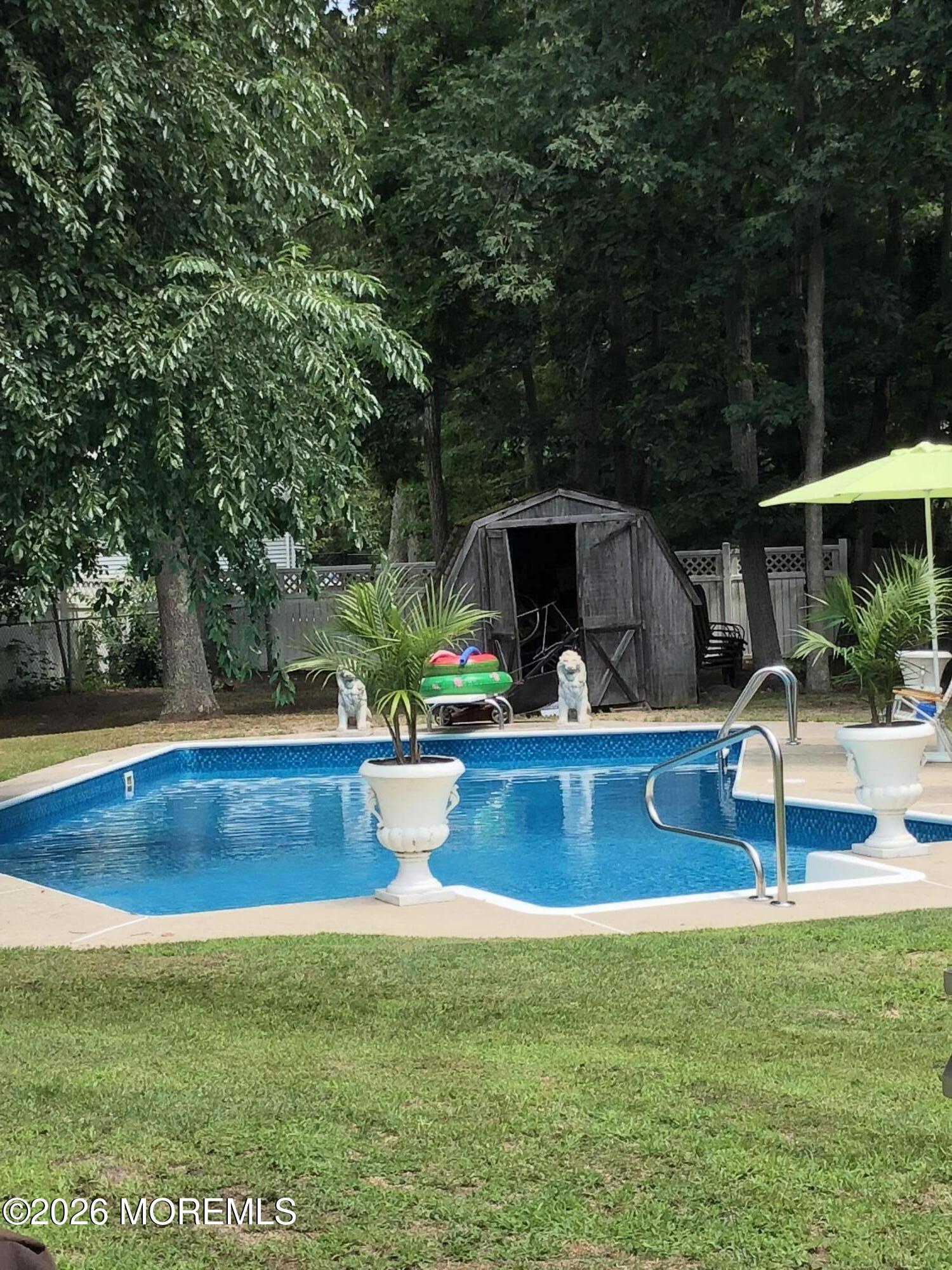 18 Liverpool Court Jackson, NJ 08527 - Photo 16 of 16 a view of a swimming pool with a patio