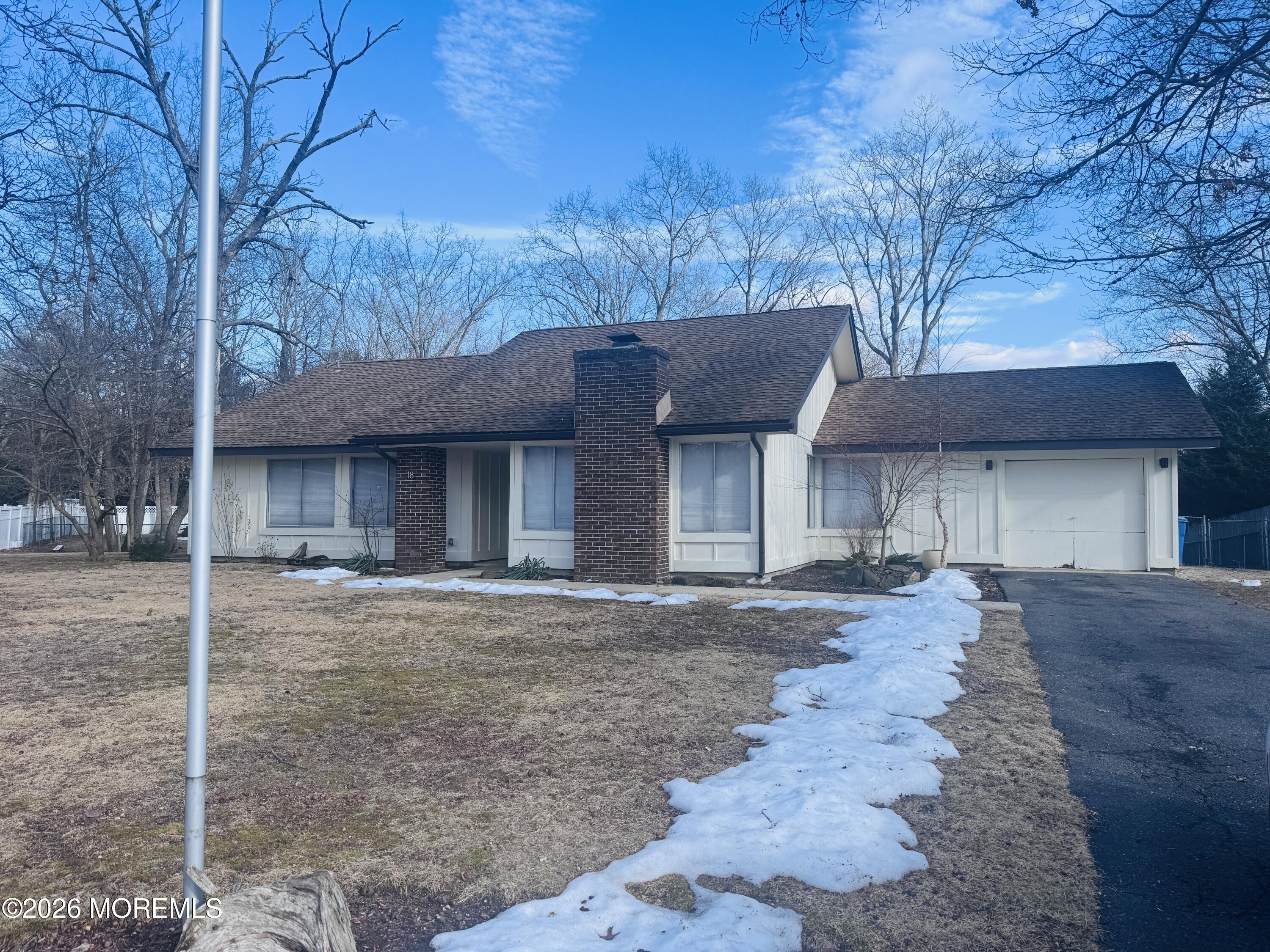 18 Liverpool Court Jackson, NJ 08527 - Photo 2 of 16 a front view of a house with a yard and garage