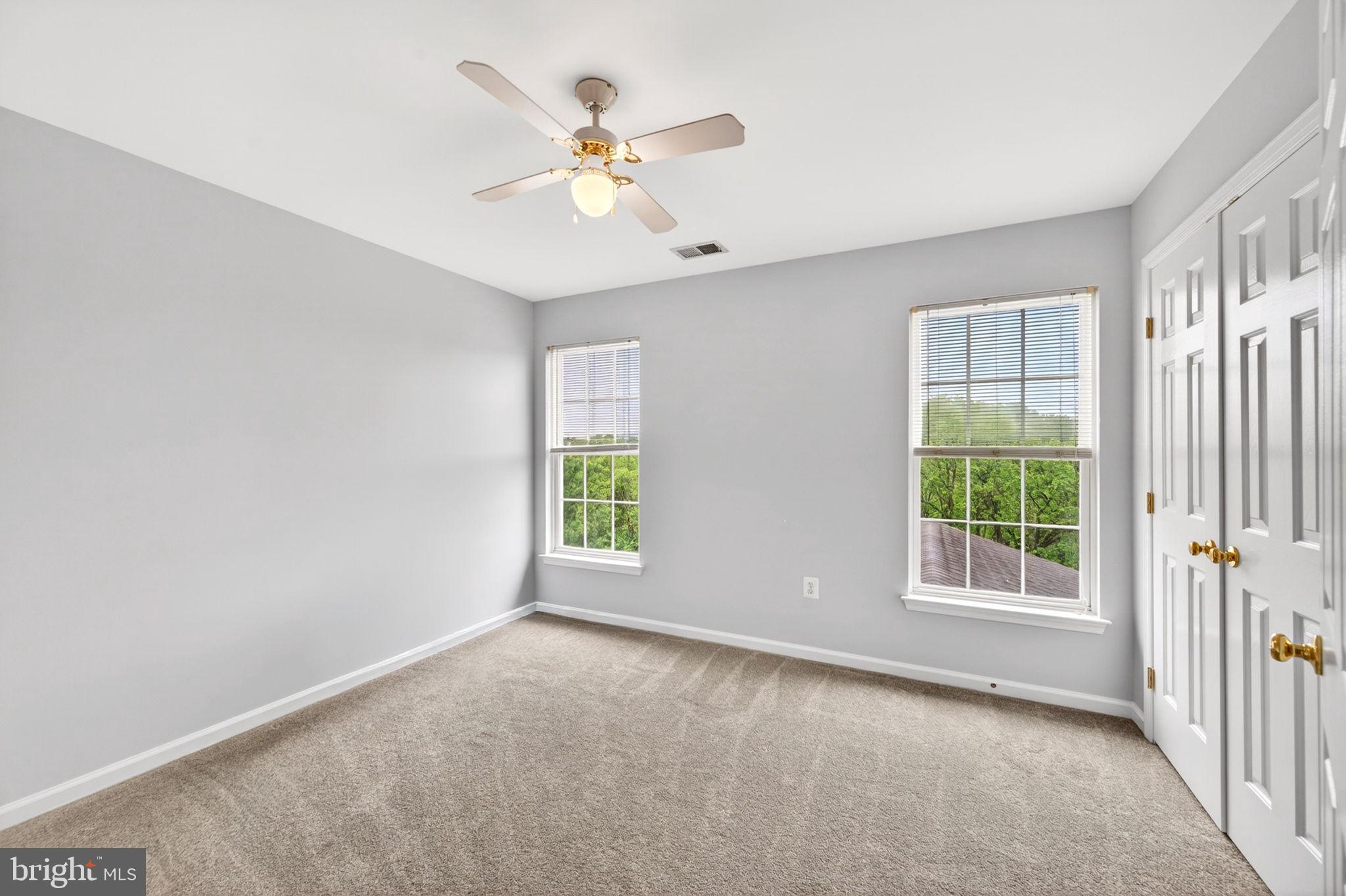 8 North Pointe Terrace Middletown, MD 21769 - Photo 38 of 74 an empty room with windows and chandelier fan
