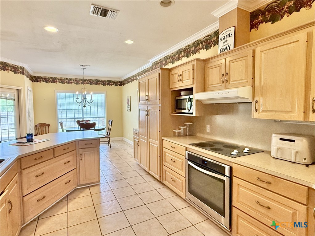 415 South Trinity Street Edna, TX 77957 - Photo 15 of 46 a kitchen with stainless steel appliances granite countertop a stove and a sink