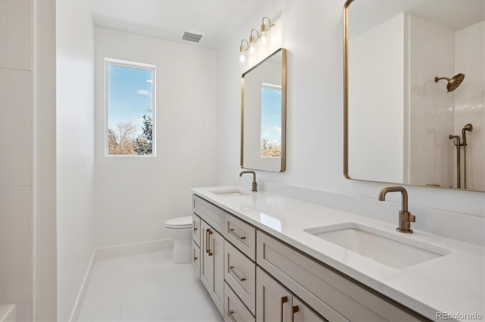 396 East Orchard Road Centennial, CO 80121 - Photo 25 of 34 a bathroom with 2 sink and a mirror