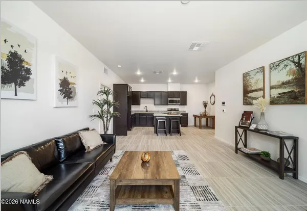 a living room with furniture and kitchen view