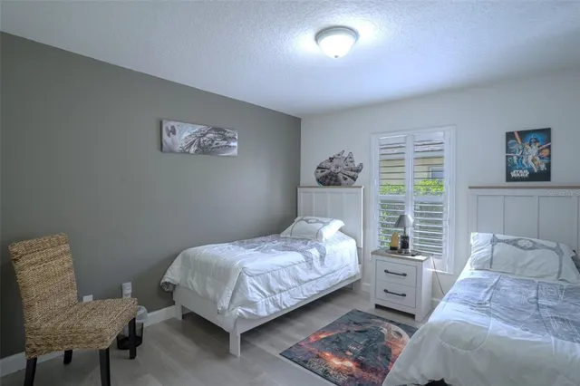 a bedroom with a bed and a chair