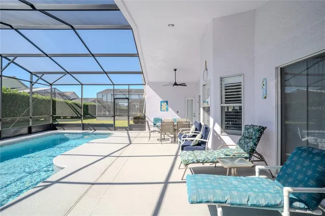 a swimming pool with outdoor seating and yard